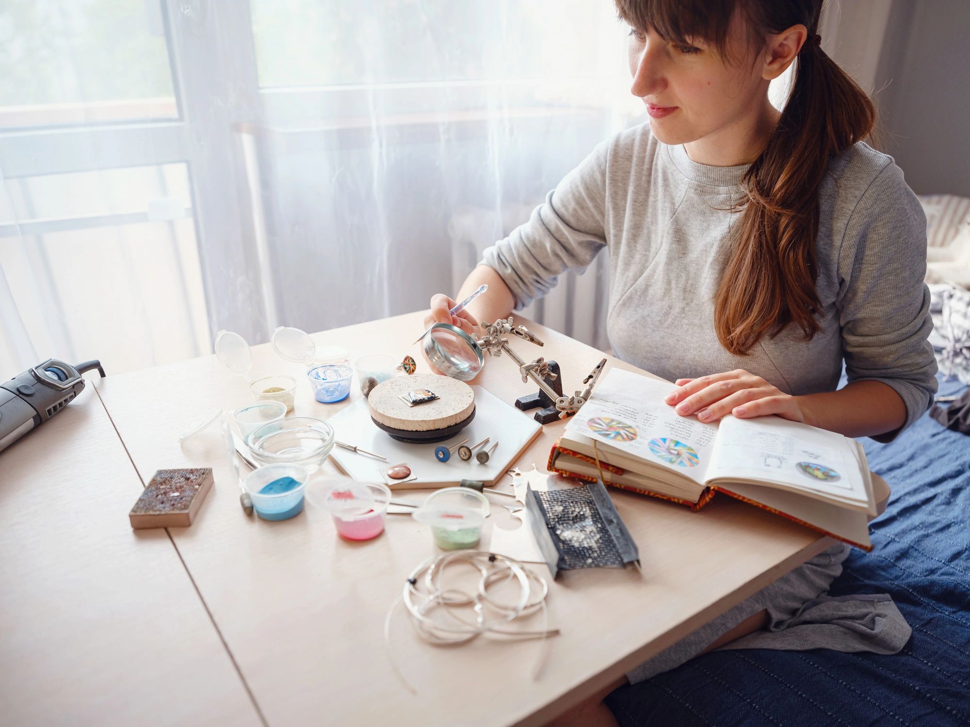Jewelry designer workspace with tools and handcrafted accessories