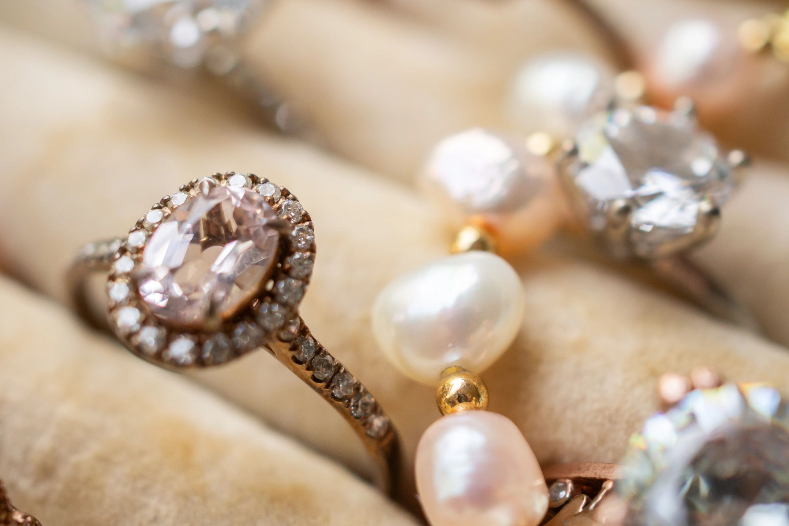 Luxury diamond rings and pearl jewelry displayed in an elegant velvet box